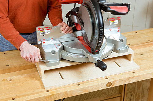 Attaching miter saw to wooden platform with carriage bolts