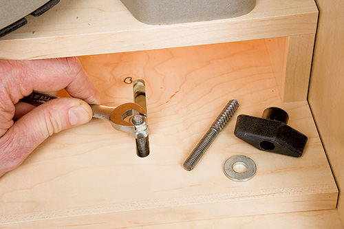 Close-up of miter saw platform slots and attachment hardware
