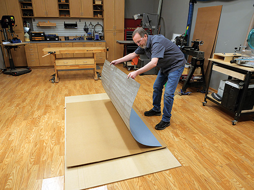 Laying laminate sheet out over cardboard seperator