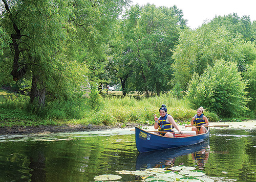 Rowing handmade canoe on lake