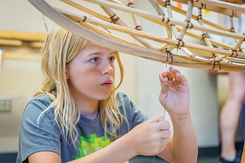 Tying together parts of canoe hull