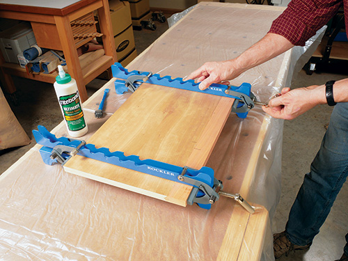 Gluing edge veneer to panel with panel clamp
