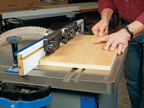Using multiple featherboards to guide edge router cut