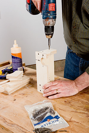 Screwing together bracket piece for wall mounted drill press