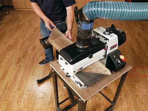 Sanding walnut tabletop pieces with a drum sander