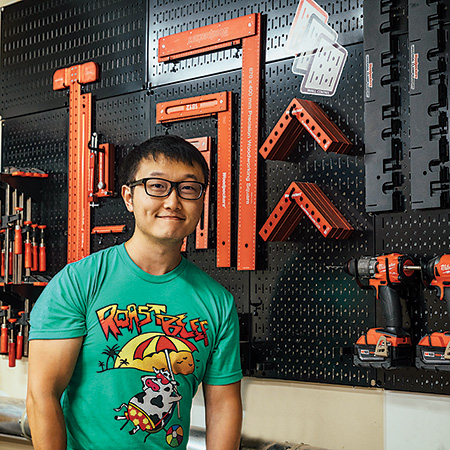 Alex Fang posing in his workshop