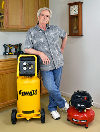 AJ Hamler posing with his shop's air compressors