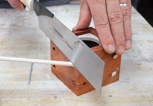 Using Japanese saw to trim ends off dowels in wireless speaker case