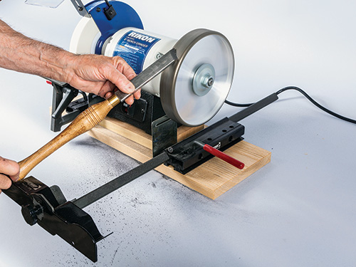 Turning tool balanced on skew jig for sharpening