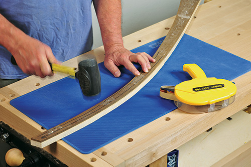 Using hammer to place template on music stand leg