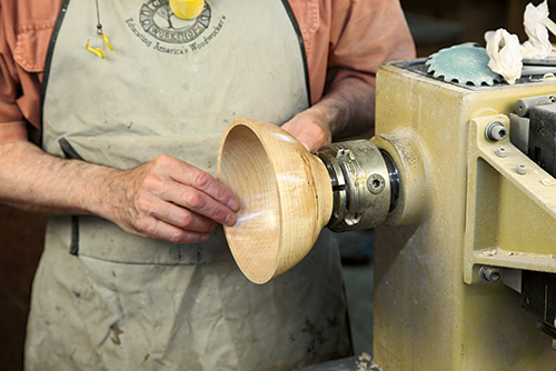 easily break when cutting and machining the shape). Center punch the hole centers and bore the openings. (See the photo sequence at left.) Using a drill with a brad point, drill carefully from the outside until the point just pokes through the inside. Now drill from the inside where the point poked through. The result is a perfect breakout on both sides. Use a coping saw to follow the outline of the J-shaped design. I use a blade that cuts in any direction, as the frame cannot clear a bowl with a normal blade. Follow up with the rotary tool to refine the shape and smooth the edges. Files are useful here as well. Getting a good, smooth edge is a bit trickier in practice than it may seem. I am afraid that you will need to hand sand the form as well. Any rough bit of edge will snag the yarn and cause troubles for your favorite knitter. Don’t forget to apply finish to the edge of the cutout scroll. I hope that next holiday season your effort gets you a nice pair of hand knitted socks or a hat to keep you warm. After all, one good turn deserves another.