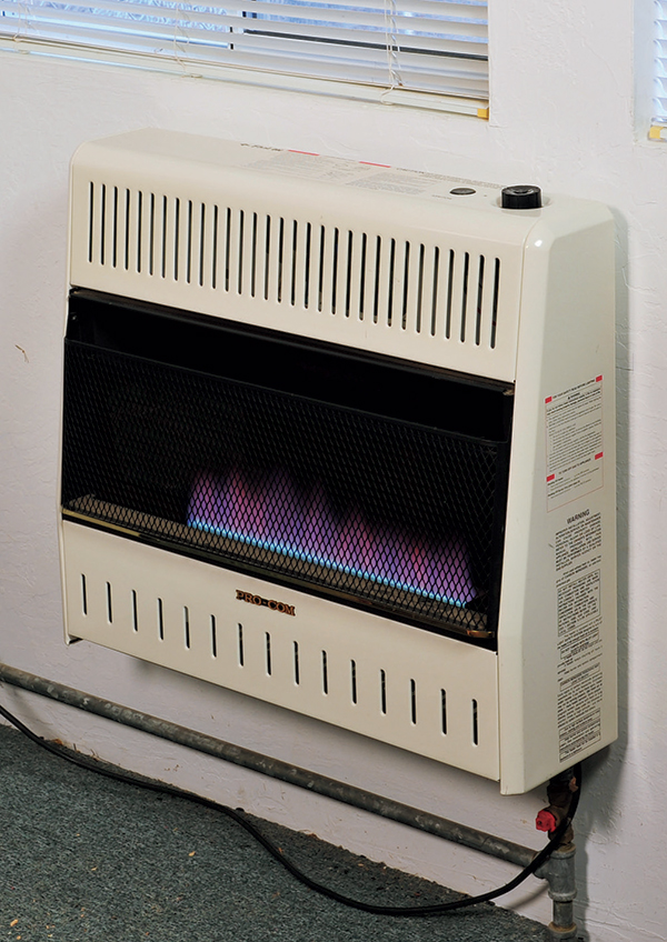  This direct vent wall heater’s bluish flames indicate that it is a convection model. It uses a fan to distribute heated air around the shop more quickly.