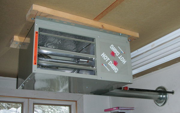 A ceiling-mounted gas-fired unit heater can be a great way to heat a big shop economically.