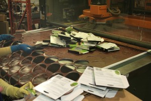 Look familiar? Here, 5-in. random-orbit sanding discs are die cut from the larger roll and packaged by hand at the end of the production line.  