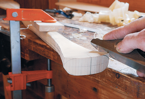 7. Shape the radius corners with a block plane. Work in from the end of the handle to prevent chipping on the edges. Continue shaping the handle with a combination of the block plane, spokeshave and carving knives. 