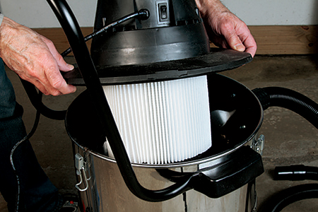 Milwaukee’s large pleated filter allows plenty of airflow but still leaves a generous space in the canister for debris. The power switch on the motor housing is small and hard to see.