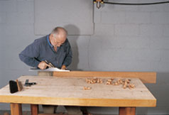 The proper hand grip demonstrated for a bench plane.