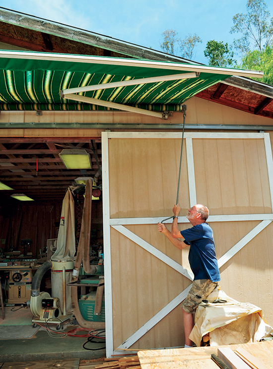 A retractable awning mounted on the front of Dale Stauffer's shop creates shade that helps keep his shop cooler in hot weather.