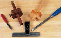 A good mortise and tenon joint starts with the right marking out tools. The author recommends, from left to right, marking knife, mortise gauge, cutting gauge, mortise chisel, and try square.