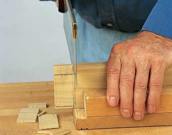 Flip the piece over while still in the bench hook and saw the edge shoulders.
