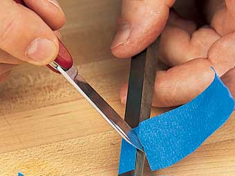 Apply masking tape to the back side of the chisel to establish your cutting depth. Tape wrapped around the chisel will crush and tear as you reach full depth.