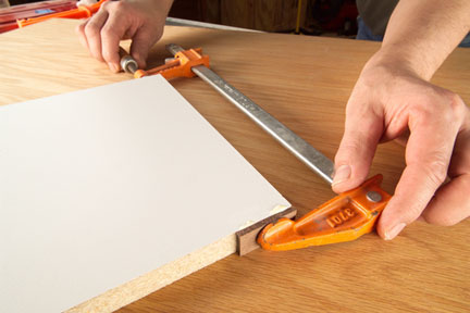 Photo 2 : Make the sled by gluing a hook on to a piece that's been ripped to a perfect 10-in. width.