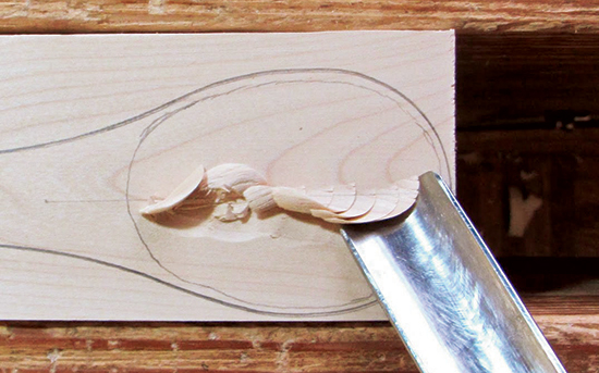 Push the gouge into the wood, working directly across the grain. Then move the handle laterally to make a slicing cut. It is best to remove wood from the center of the bowl first.