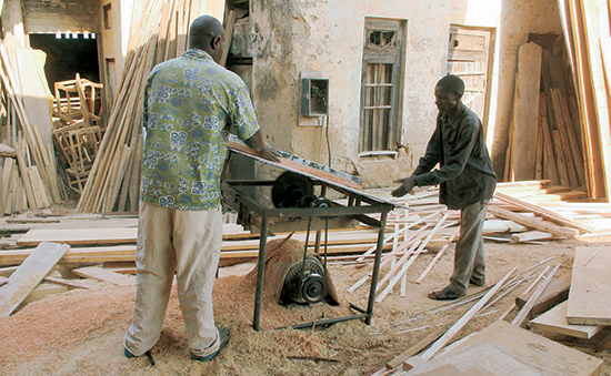 With this Ugandan tilt-top table saw, the lower the angle, the deeper the cut. 