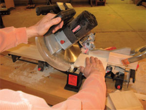 Figure 1. Chopping the miters on the Top, Bottom and Ends can be done on a miter saw. To form the 6-inch long ends, set a stop block and flip the stock as you chop to form the miters on the proper face.