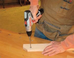 Figure 4. Boring the hole for the Shaker pegs is easily done with a handheld, battery-powered drill. A Forstner, or even a paddle, bit will do the job nicely. Drill the hole deep enough to seat the pegs securely.
