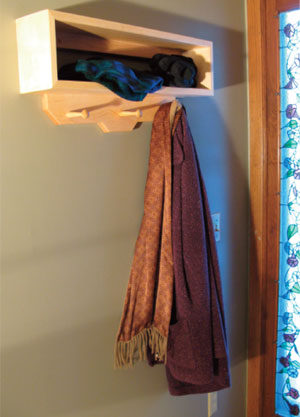 Figure 7. When mounted securely to the wall by a door opening, this wall-hanging storage unit becomes a handy place to hang coats, hats, sweaters and scarves.